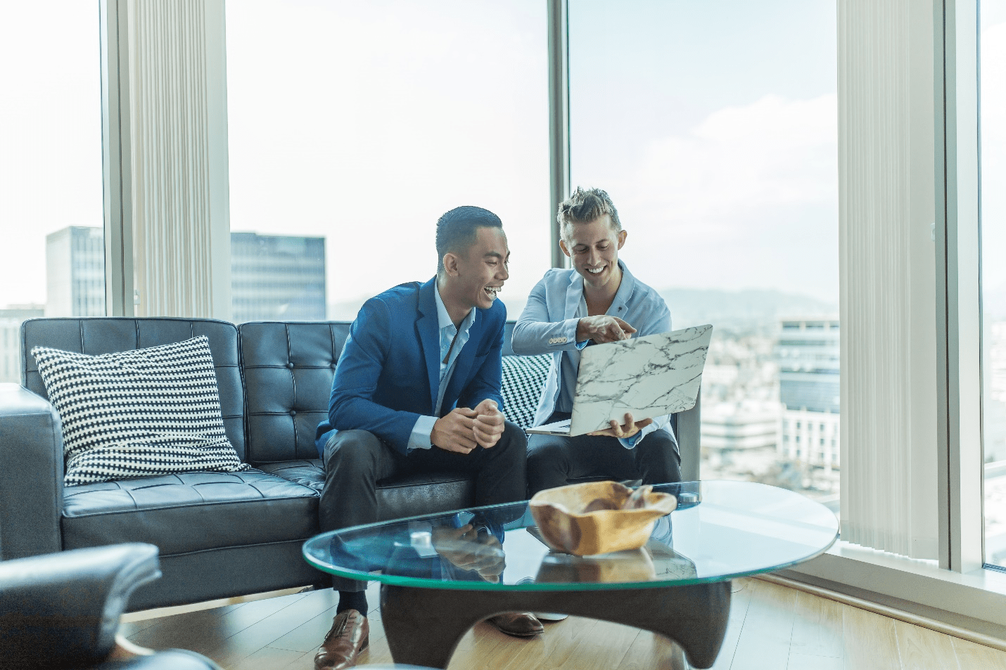 Business Men Sitting and Looking at a Laptop